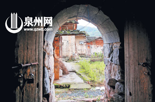 這一石拱門是土樓的邊門，對面是土樓的配套古厝。